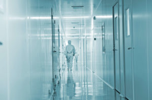Pharmaceutical Technicians walking in sterile coveralls in a clean room facility