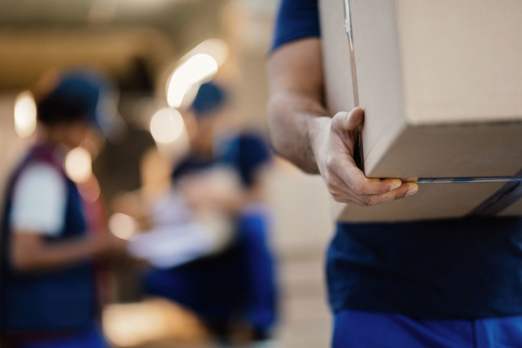 Closeup of unrecognizable man with cardboard box